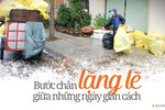 Chú Lê Thanh Tuấn dầm mưa bốc rác trên đường An Bình, quận 5, TP.HCM