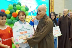 Thượng tọa Thích Thiện Quý trao quà cho các em học sinh khó khăn - Ảnh: H.D