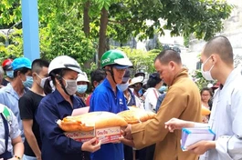 Thượng tọa Thích Thiện Thông, trụ trì chùa Liên Trì trao quà đến người dân khó khăn