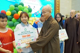 Thượng tọa Thích Thiện Quý trao quà cho các em học sinh khó khăn