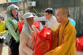 Thượng tọa Thích Đạo Phước, trụ trì chùa Thiền Giác, cùng đại diện chính quyền tặng quà Vu lan đến người dân khó khăn tại P.Phú Hữu