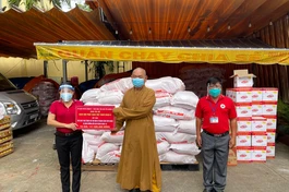 Thượng tọa Thích Huệ Công trao bảng hỗ trợ đến bà Phạm Thị Minh Nguyệt, Phó chủ tịch UBMTTQVN quận 8