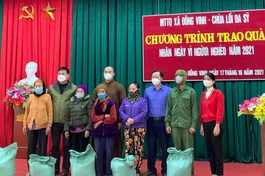 Đại đức Thích Nguyên Giới trao gạo đến các hộ nghèo tại xã Đông Vinh