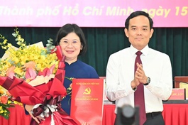 Bí thư Thành ủy TP.HCM Trần Lưu Quang trao quyết định và tặng hoa chúc mừng bà Văn Thị Bạch Tuyết