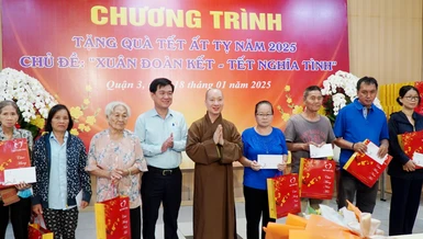 Thượng tọa Thích Nguyên Các, Phó trụ trì chùa Vĩnh Nghiêm, cùng ông Huỳnh Gia Giang, Chủ tịch UBMTTQVN Q.3 trao tặng quà Tết đến bà con trên địa bàn quận