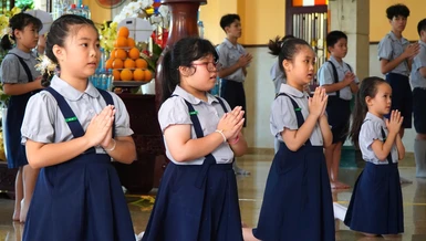 Ý Lạc (thứ hai từ trái qua) cùng các bạn đoàn sinh Gia đình Phật tử tụng kinh tại chùa Xá Lợi - Ảnh: Như Danh/BGN