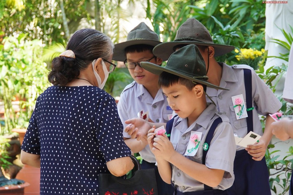 Các em Oanh vũ Gia đình Phật tử Xá Lợi cài hoa hồng Vu lan đến Phật tử sáng Rằm tháng Bảy