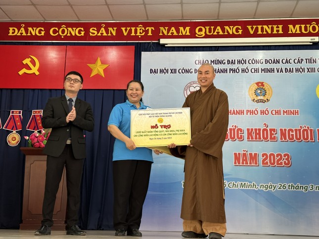 Đại đức Thích Minh Phú trao bảng hỗ trợ đến đại diện Liên Đoàn Lao động TP.HCM