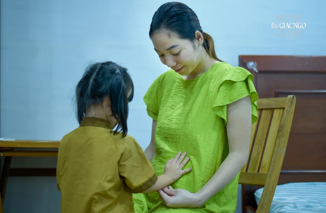 Từ chùa trở về, bé Bông liền chia sẻ niềm vui và sự bình an đó đến mẹ và em trai trong bụng mẹ