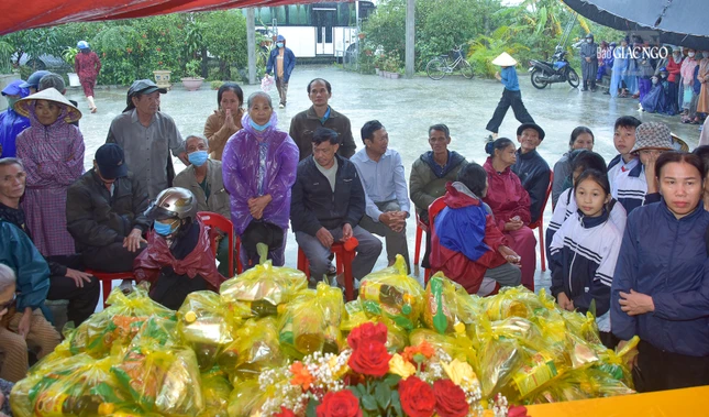 Người dân trên địa bàn H.Quảng Trạch ngồi chờ nhận quà dưới trời mưa lớn