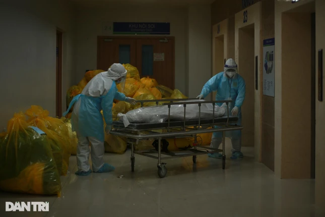 Giữa đêm, không khí bên trong khu hồi sức trở nên trầm xuống, mọi ánh mắt đều hướng về phía chiếc xe đẩy giữa hành lang. Một bệnh nhân 85 tuổi mắc Covid-19 vừa tử vong do bệnh nền nặng. Nhân viên y tế thực hiện quy trình xử lý nghiêm ngặt đối với ca bệnh tử vong rồi chuyển đi làm thủ tục, và báo về cho gia đình.