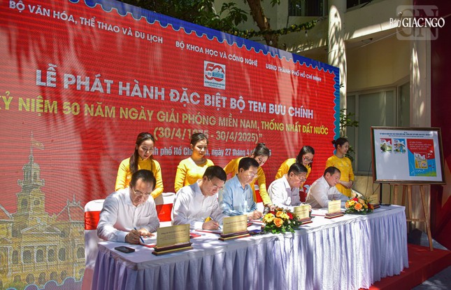 Các đại biểu ký và đóng dấu phát hành bộ tem bưu chính đặc biệt kỷ niệm 50 năm thống nhất đất nước