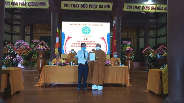 Ông Nguyễn Hữu Dinh trao quyết định của UBND tỉnh về việc thành lập GHPGVN huyện Khánh Vĩnh đến đại diện Ban Trị sự Phật giáo tỉnh