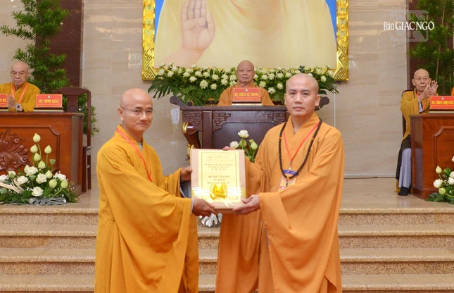 Thượng tọa Thích Thiện Quý trao đề thi đến Thượng tọa Thích Minh Cần, đại diện Ban Giám khảo