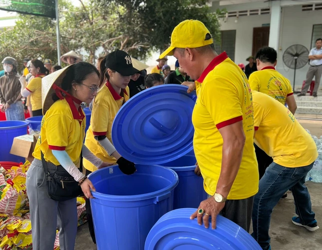 Tặng thùng chứa nước và quà đến người nghèo - Ảnh: T.N