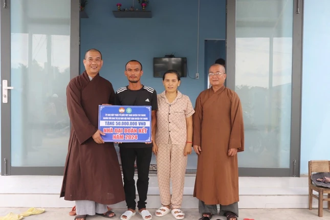 Đại diện Ban Trị sự H.Tuy Phước trao bảng ủng hộ đến gia đình anh Tuyến