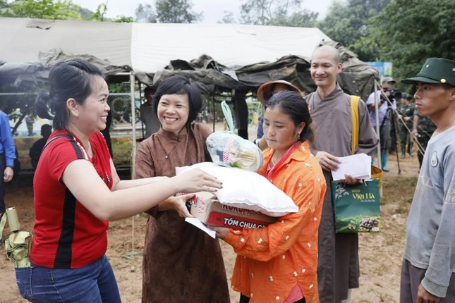 Thành viên đoàn trao quà đến bà con vùng lũ