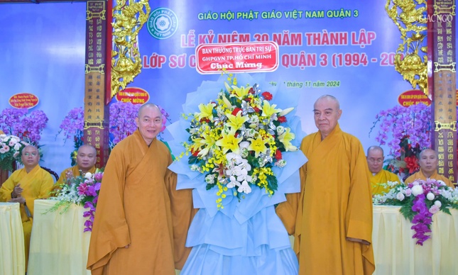 Hòa thượng Thích Nhật Hỷ trao lẵng hoa chúc mừng của Ban Thường trực Ban Trị sự GHPGVN TP.HCM do Thượng tọa Thích Thiện Bửu đón nhận