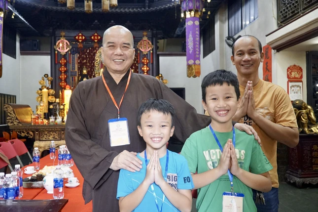 Phật tử nhỏ tuổi tham dự hội thi tại chùa Vạn Phật, Q.5 lưu niệm bên Thượng tọa Thích Truyền Cường - Trưởng ban Trị sự, Trưởng ban Tổ chức