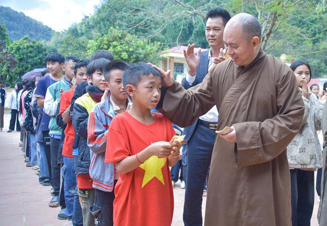 Một em học sinh vui vẻ nhận quà từ Thượng tọa Thích Đức Thiện