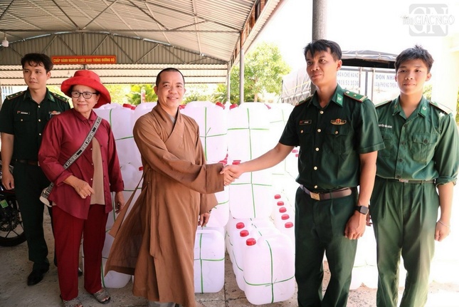 Đại đức Thích Huệ Lý phối hợp với bộ đội biên phòng hỗ trợ can chứa nước để vận chuyển nước sinh hoạt đến bà con khó khăn