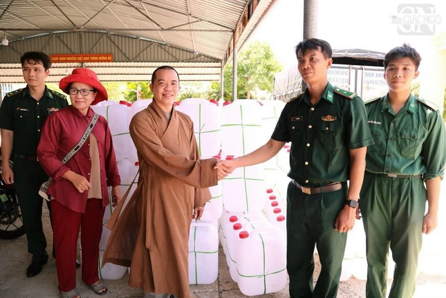 Đại đức Thích Huệ Lý phối hợp với bộ đội biên phòng hỗ trợ can chứa nước để vận chuyển nước sinh hoạt đến bà con khó khăn