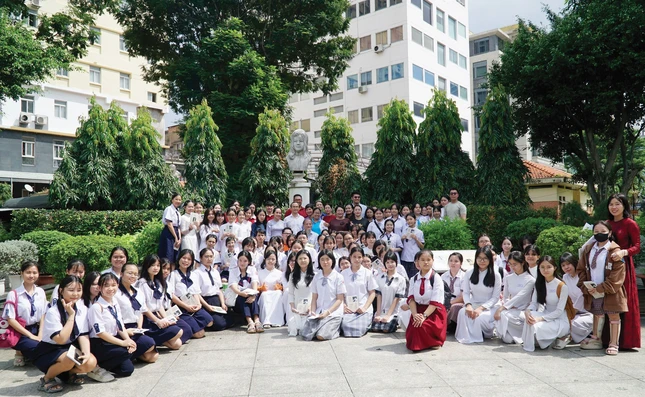 Các em học sinh cùng thầy, cô và PGS.TS Nguyễn Thiện Tống lưu niệm tại Tượng đài Liệt nữ Quách Thị Trang