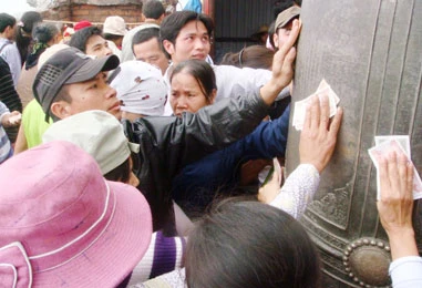 Dùng tiền để xát lên chuông, làm các chữ Nho bạc trắng, lu mờ hẳn