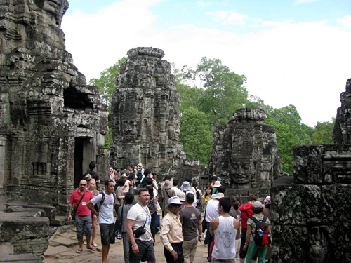 Cụm đền Angkor Wat vào buổi sớm mai. Rất nhiều du khách sẵn sàng thức dậy từ 5h sáng để kịp có mặt ngắm bình minh lên. Dù lượng khách du lịch tới Angkor rất lớn nhưng khu di tích này vẫn giữ được những nét bình yên. Bạn có nhiều lựa chọn để đi khám phá nơi đây, bằng xe đạp, thuê tuk tuk, cưỡi voi và cả bay trên khinh khí cầu. Những nụ cười bí ẩn của tượng đá khổng lồ ở đền Bayon. Những bức tượng trên đường dẫn vào Angkor Thom. Không chỉ nổi tiếng về mức độ hoành tráng, các công trình ở Angkor còn rất tinh xảo trong các đường nét chạm trổ. Không khó hiểu khi có nhiều người dành vài ngày hoặc cả tuần chỉ để thăm quan di sản văn hóa thế giới này. Không chỉ có những đền chính, nếu có thời gian bạn nên tới những đền nhỏ. Màu xanh của cây cối càng làm nổi bật thêm nét đẹp huyền bí của Angkor. Nhìn những khối đổ nát cũng đủ biết quy mô của công trình trước đây. Những rễ cây khổng lồ bao trùm lấy các bức tường, khu nhà.