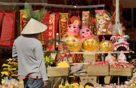 Một người bán hàng ngắm giá để đồ bày Tết.