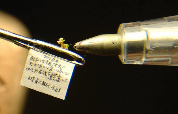 A miniature tiger sculpture, carved by Chen Forng-shean, is placed on a needle at his home in Hsintien, Taipei county, Taiwan