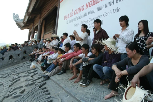 Chiếc bánh dày được hạ xuống... ... trong sự hoan hỉ của Phật tử bốn phương. Nhân dân háo hức chờ đón giây phút được thụ lộc. Nhiều người đứng ở xa cũng cố gắng xem cho rõ. Trụ trì chùa Bái Đính làm lễ tế. Không khí trang nghiêm. Âm vang tiếng mõ. Phật tử bốn phương tỏ lòng thành kính. Lễ tế diễn ra trong không khí trang nghiêm. Đội tế nữ đang thực hiện nghi thức dâng bánh dày. Chiếc bánh dày được để tại Tam Tòa, của Bái Đính Cổ Tự sau đó phát lộc cho 1 vạn Phật tử.