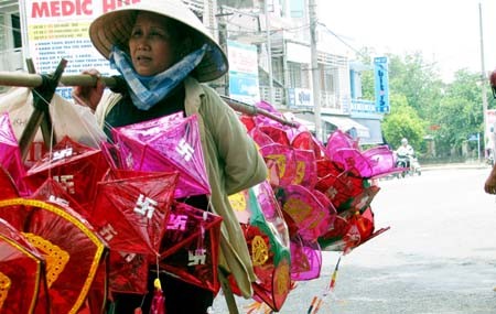 Mỗi ngày, gánh đèn lồng đi qua nhiều con phố và trên áo ướt đẫm mồ hôi