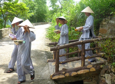 Hơn 600 học sinh tề tựu trong lễ khai giảng. Buổi học thiền đầu tiên. Không giấu nổi sự hồn nhiên. Cùng nhau xuống núi đi khất thực. Cười hồn nhiên trong giờ tiểu thực. Tập trung trở lại khu nhà ở sau giờ ăn trưa. Sư thầy nhẹ nhàng nhắc nhở các em nhỏ đi đúng hàng. Hai em nhỏ tranh thủ giờ nghỉ trưa xem lại bài vở. Các em cùng nhau học Phật pháp. Vốn là nơi tu hành của các bậc chư tăng, song để đáp ứng nhu cầu chúng sinh, Thiền viện Trúc Lâm Tây Thiên đã nhận giúp các "cậu ấm, cô chiêu" tập tu, sửa mình mà không thu bất cứ khoản lệ phí nào. Lớp học năm trước chỉ có 40-50 em nhỏ, do tiếng lành đồn xa, năm nay con số đã gấp hơn 10 lần. Các thầy phải chia làm nhiều khóa học để tiếp nhận các em. Khóa học đầu tiên dành cho các em từ 10 đến 14 tuổi, khai giảng vào ngày 13/6 và sẽ kết thúc sau 2 tuần. Thiền sư Thích Kiến Nguyệt, trụ trì Thiền viện Trúc Lâm Tây Thiên cho biết, do khuôn viên và số lượng thiền sư có hạn nên không thể nhận cùng lúc tất cả em nhỏ. Hiện 90 thầy, cô phải làm việc hết mình để quản lý, dạy dỗ 600 em nhỏ. Nói về lợi ích của việc tu tập, đặc biệt là ngồi thiền, thầy Nguyệt nhận xét: “Thiền là phương pháp tĩnh tâm khai trí. Khoa học đã chứng minh đứa trẻ ngồi thiền thông minh, kiên nhẫn hơn những đứa trẻ không ngồi thiền. Hiện nay, ở nhiều nước đã đưa thiền vào chương trình giáo dục. Các em tranh thủ đọc sách Phật trong giờ nghỉ. Ảnh: Hải Đăng. Ngoài việc học thiền, các sư thầy, sư cô sẽ chỉ dạy cho các em thói quen thức dậy từ 3h sáng, gập chăn màn sao cho vuông vức, ngay ngắn, sau đó nhẹ nhàng di chuyển về giảng đường để tọa thiền. Kết thúc giờ tọa thiền lúc 5h sáng, các em sẽ đến với bữa sáng gọi là tiểu thực. Lũ trẻ tay cầm bát, xếp thành hàng dài ngay ngắn đi về phía Trai đường để tự chọn khẩu phần ăn chay cho mình. 7h30 là bắt đầu giờ học đạo. Các em nhỏ được dạy kinh Phật để biết nhìn vạn vật bằng tình yêu thương, biết đúng, biết sai để sớm "phát tâm tỉnh giác, xa lìa chỗ tối tăm". 11h trưa là đến giờ khất thực (ăn trưa). Trước khi ăn, lũ trẻ phải chắp tay cầu nguyện và cùng nghe thầy giảng về nguồn gốc hạt lúa, củ khoai, ý nghĩa của những bữa ăn chay... Buổi chiều những cậu ấm, cô chiêu vốn quen với nếp sống thị thành, quen với sự nuông chiều, ỉ lại vào cha mẹ, người thân, được dạy cách làm việc nhà như: nấu cơm bằng bếp củi, rửa bát, nhặt rau... Các em kết thúc một ngày bằng lễ sám hối tại chánh điện, tức là xem xét lại tất cả những hành động trong ngày để nhận biết đúng, sai và sửa mình. Có nhiều lý do để các bậc phụ huynh đưa con em đến tập tu. Người thì muốn con tách khỏi cuộc sống thường nhật để cai games, người muốn con được học Phật pháp để chúng hiểu rõ hơn về ý nghĩa cuộc sống, trân trọng những gì đang có, để chúng biết được nguồn gốc của hạt lúa, củ khoai, biết trân trọng thành quả lao động của người khác. Và cũng có những ông bố bà mẹ đưa con lên chỉ để con biết thế nào là nhặt rau, quét nhà, nấu cơm… Chia sẻ cảm giác về ngày đầu tập tu, cô bé Phạm Phương Thảo, 14 tuổi, thật thà: “Cháu chẳng muốn lên đây, ở đây chán lắm, chẳng qua là bố mẹ ép. Cháu nghiện Audition nặng, chỉ cần hai chai nước, chẳng cần ăn gì, cháu có thể ngồi cả ngày. Giờ này bọn bạn cháu chắc đang ngồi ở quán net đầu đường Tô Hiệu (Cầu Giấy, Hà Nội)". Khác với sự bạo dạn của Thảo, hai chị em Nguyễn Việt Hà (14 tuổi) và Nguyễn Việt Hương (6 tuổi) ở Đống Đa (Hà Nội) tỏ ra dè dặt khi tiếp xúc với người lạ. Hương nhỏ tuổi nhất tại khóa học lần này. Thấy bố mẹ đưa chị lên đây để có thời gian nghỉ ngơi sau một năm học vất vả, cô bé nhất định đòi lên cùng chị. Đôi mắt sưng húp, Hà nói: “Hết giờ sám hối chiều qua, em cháu bắt đầu khóc đòi mẹ. Các cô dỗ mãi nó mới chịu nín. 11h đêm nó lại khóc, thế là cả phòng cháu khóc theo. Cháu nhớ nhà lắm. Cho cháu mượn điện thoại để gọi về cho mẹ được không?”. Được mượn điện thoại, cô bé vừa bấm số gọi cho mẹ vừa nước mắt lưng tròng. Cô chị ôm lấy cô em, thút thít nói chuyện với mẹ… Một em trai cũng không cầm được nước mắt vì nhớ nhà. Ảnh: Hải Đăng. Phía ngoài bậc thang bước lên giảng đường, hai ni cô cũng ra sức dỗ dành cậu bé Bùi Công Huy (10 tuổi) ở Hà Giang đang đòi về. Huy vừa khóc vừa nói: “Cháu không quen ăn chay, nhạt lắm. Ở đây cháu còn phải tự gập quần áo, nấu cơm, rửa bát, đến giờ ăn còn phải tự bưng bát, xếp hàng xới cơm… Cháu không quen, cháu muốn về với mẹ”. Các em lớn thì tỏ ra cứng rắn và thích nghi nhanh hơn với nếp sống tại thiền viện. Khuôn mặt tuấn tú, đeo kính cận, cậu bé Phan Thành Hưng (16 tuổi) ở phường Bách Khoa, Hà Nội, nhẹ nhàng lật giở quyển kinh. “Đây là lần thứ hai em lên thiền viện. Năm ngoái vì quá nghiện Internet nên bố mẹ đưa em lên. Năm nay, nghỉ hè là em xin bố mẹ lên luôn. Bây giờ em đã quen với việc ăn chay, dậy sớm từ 3h sáng, tự xúc khẩu phần ăn cho mình, tự rửa bát, quét nhà. Các thầy, các cô chỉ bảo ân cần lắm”, Hưng chia sẻ. Bóng chiều buông xuống, anh Quách Ngọc Huy (Tây Hồ, Hà Nội) đang chuẩn bị chia tay hai cô con gái để về Hà Nội. "Tôi có 3 con gái và muốn cả ba cháu lên đây nhưng vì cháu út mới 4 tuổi nên đành phải ở nhà với mẹ. Thú thật lên đây tôi thấy không khí thật thanh bình. Nhìn thấy con tự rửa bát, quét nhà mà tôi mừng quá. Ở nhà chúng có biết làm gì đâu. Tôi mong nhà chùa mở thêm nhiều khóa học như thế này để các em có được một học kỳ 3 thật hữu ích", anh Huy nói. 18h30 chiều, mặt trời đỏ lự phía sau mái chùa cong cong. Hàng thông reo vi vu. Phía nhà dân dưới chân núi, mấy cột khói bếp mịt mùng hòa vào khói lam chiều. Trên giảng đường ở thiền viện, đám trẻ nghiêm trang chắp tay trước tượng Phật và cầu nguyện theo các thầy để chúng sinh “xa rời đường dữ”, được ấm no, hạnh phúc.