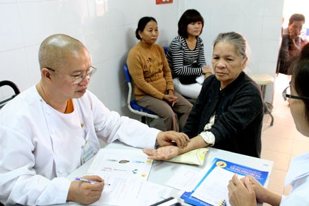 Sư không mặc áo vàng ảnh 1 Hoà thượng, lương y Thích Tuệ Tâm (trái ảnh) đang khám bệnh tại Tuệ Tĩnh đường Liên Hoa. Ảnh: H.V.M
