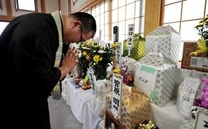 Sư Miyabe đang cầu nguyện cho các vong linh.jpg