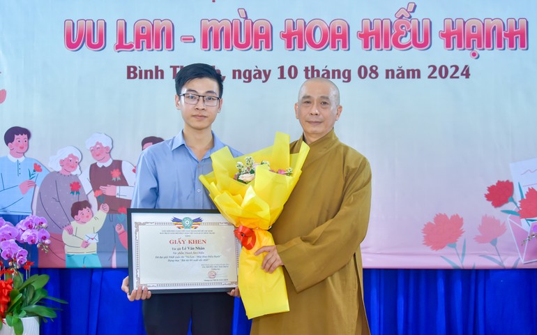 Thượng tọa Thích Tâm Chơn trao phần thưởng đến tác giả Lê Văn Nhân, người đạt giải nhất cuộc thi “Vu lan - Mùa hoa hiếu hạnh” do Ban Trị sự GHPGVN Q.Bình Thạnh tổ chức - Ảnh: Quảng Đạo/BGN