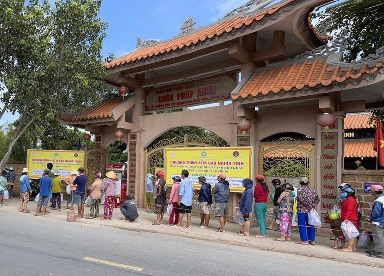 Người dân xếp hàng nhận gạo tại "ATM gạo nghĩa tình" ở chùa Pháp Minh