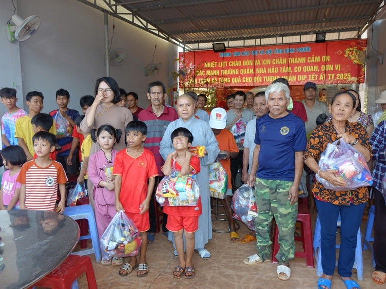 Ni sư Thích nữ Như Hiền trao quà đến trẻ mồ côi đang được nuôi dưỡng tại Hội bảo trợ H.Lộc Ninh