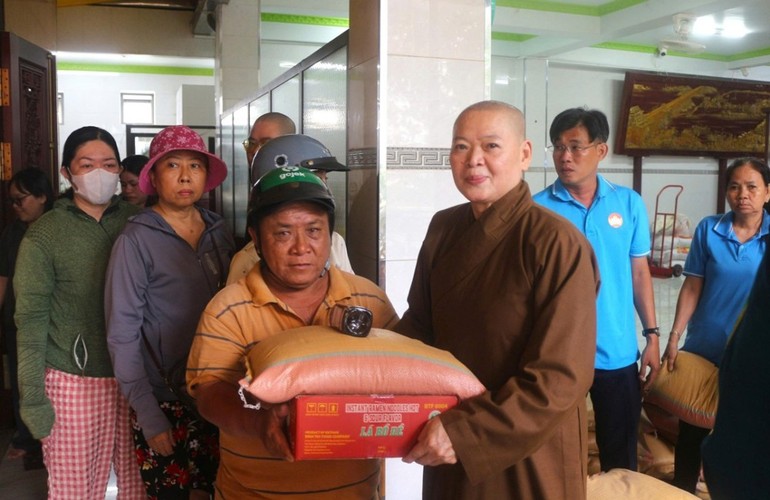 Ni sư Thích nữ Huệ Tuyến, trụ trì chùa Quan Âm trao quà Vu lan đến hộ nghèo tại P.Phú Định