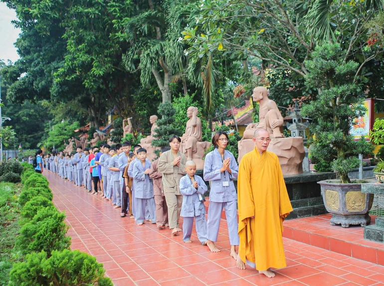 Thượng tọa Thích Tịnh Tâm, trụ trì chùa Hoằng Linh hướng dẫn các khóa sinh kinh hành trong khuôn viên chùa 