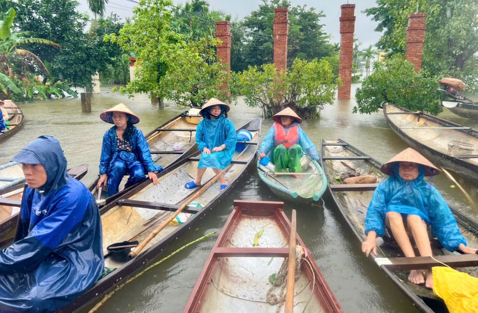 Người dân chèo ghe đến nhận quà