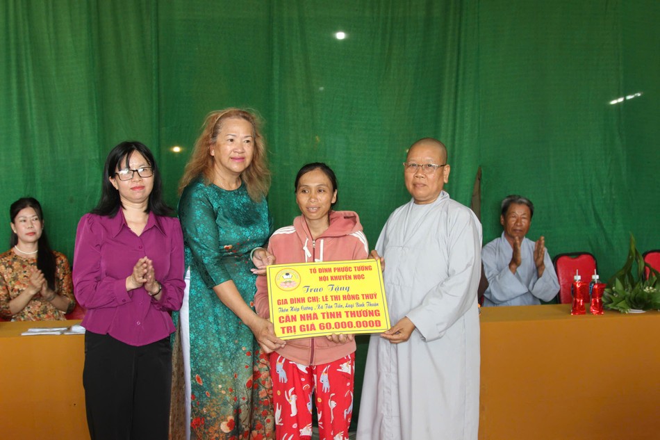 Sư cô Thích nữ Bổn Nguyên, Trưởng ban Hướng dẫn Phật tử GHPGVN thị xã La Gi, trụ trì chùa Quảng Hương trao bảng tượng trưng tặng nhà tình thương cho hộ bà Lê Thị Hồng Thủy