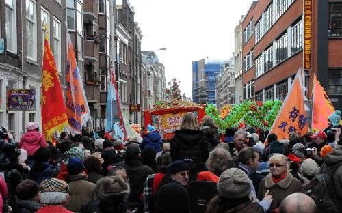 People watch a performance during a celebration for the Chinese Spring Festival, or lunar New Year, in the Hague of the Netherlands, on Feb. 13, 2010. 