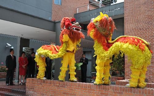 Performers perform lion dance at the Chinese Embassy in Columbia during a Chinese Lunar New Year reception in Bogota, capital of Columbia, Feb. 11, 2010.