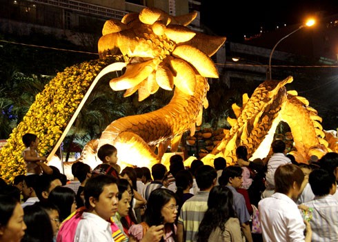 Từ 18h, dòng người đã kéo về đường hoa Nguyễn Huệ để thưởng thức cảnh đẹp được trang trí lộng lẫy và chờ đón màn bắn pháo hoa.